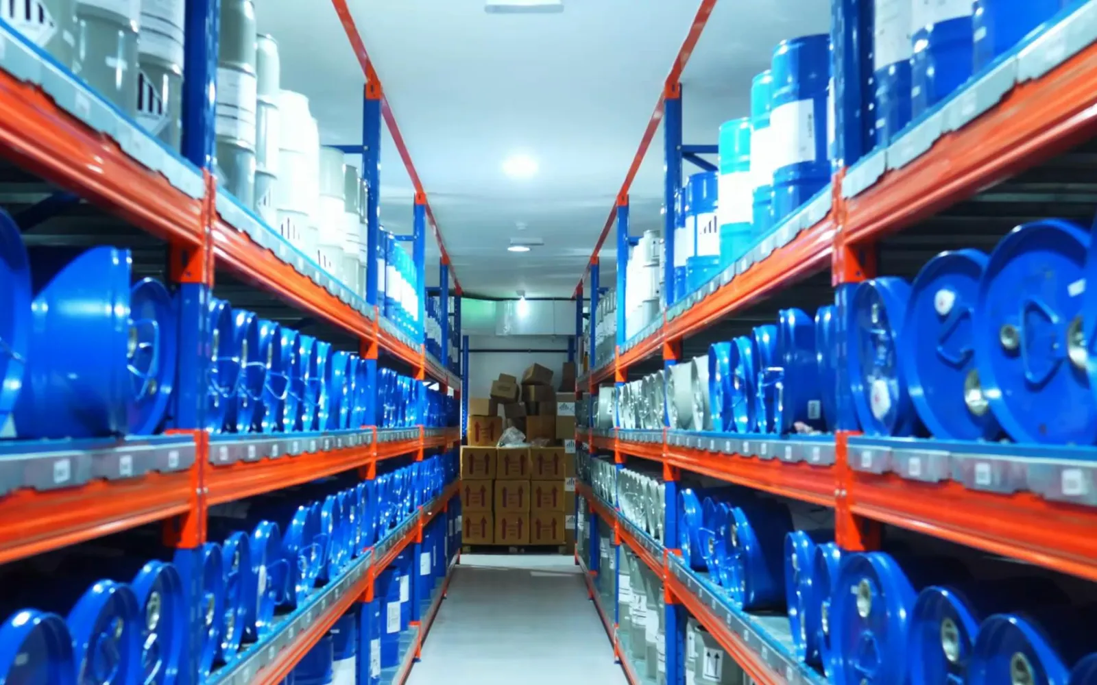 Racks of raw material drums in the Damas Rose warehouse