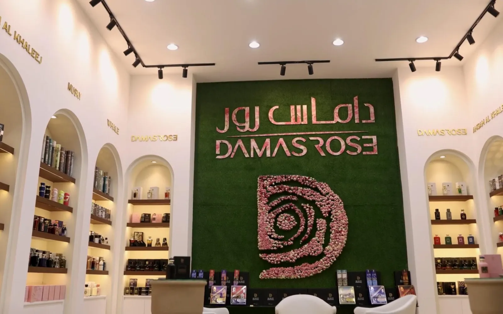 Damas Rose showroom with arched shelves and the rose emblem wall
